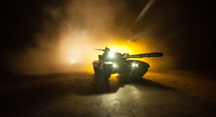 War Concept. Armored vehicle silhouette fighting scene on war foggy sky background at night. American tank ready to fight.