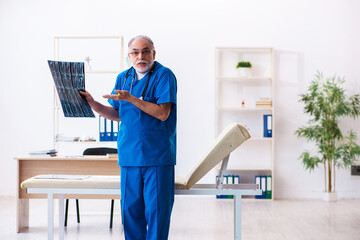 Old male doctor radiologist working in the hospital