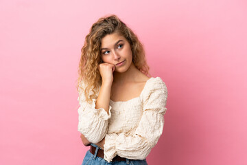 Young blonde woman isolated on pink background with tired and bored expression