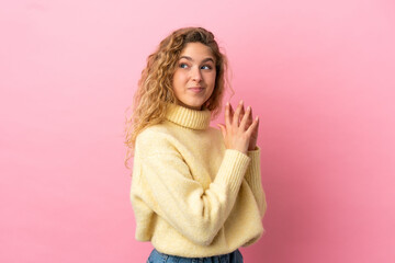 Young blonde woman isolated on pink background scheming something
