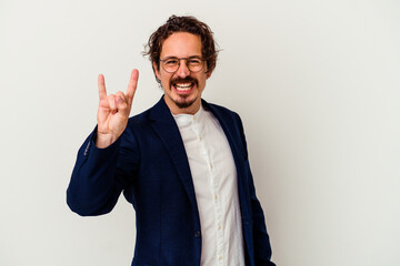 Young business man isolated on white background showing a horns gesture as a revolution concept.