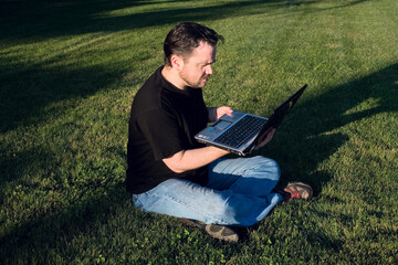 Man Working with Laptop in Park