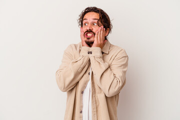 Young caucasian man isolated on white background scared and afraid.