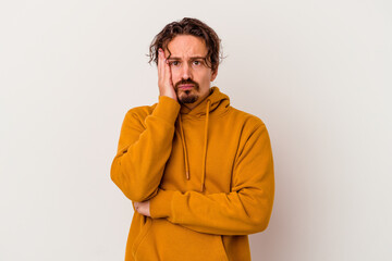 Young caucasian man isolated on white background blows cheeks, has tired expression. Facial expression concept.