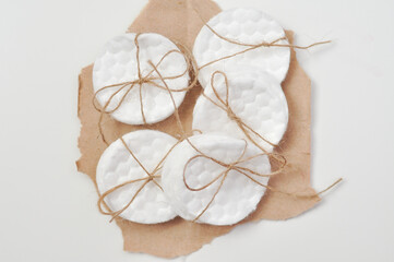 cotton pads organized in cute stripe with bow on eco paper for cleaning face and body