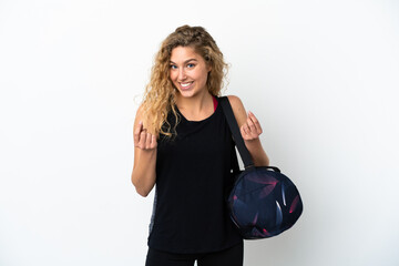 Young sport woman with sport bag isolated on white background making money gesture