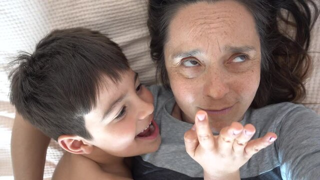 4K serial selfie 7 years long - Playful child pesters his tired mother
