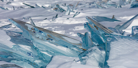 Scenic winter lake Baikal landscape with huge pressure ridge transparent ice blocks on the surface