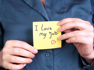 I Love My Job Note in hand, business woman or man with yellow sticky note with positive achievement, business,goals,education,people concept