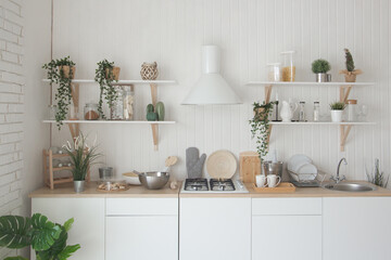 Modern new light interior of kitchen with white furniture.