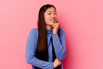 Young chinese woman isolated on pink background smiling happy and confident, touching chin with hand.