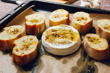 homemade DIY baked camembert with garlic.cheese with white mold.baked cheese.