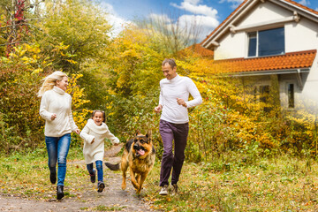 Fototapeta premium Happy family near new house. Real estate concept.