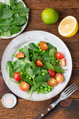 Healthy detox salad with baby spinach and cherry tomatoes. Weight loss, dieting concept. Table top view