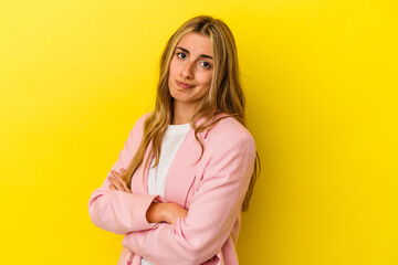 Obraz premium Young blonde caucasian woman isolated on yellow background unhappy looking in camera with sarcastic expression.