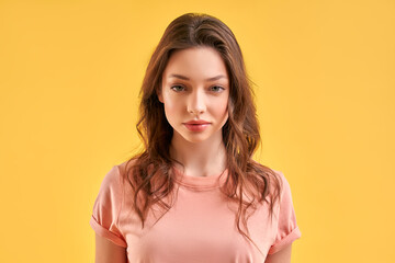 Obraz premium Beautiful girl in casual clothes isolated on yellow background.