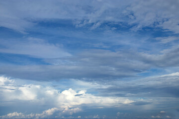 Cirrus, stratus and cumulus clouds against blue sky