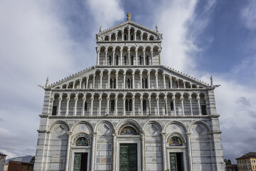 Fototapeta premium Architectural fragments of Romanesque medieval Roman Catholic Pisa Cathedral at Square of Miracles (Piazza dei Miracoli or Piazza del Duomo), UNESCO World Heritage Site. Pisa, Tuscany, Italy.