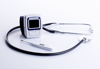 stethoscope, tonometer and thermometer on the white background