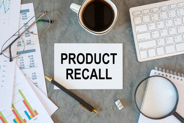 PRODUCT RECALL is written in a document on the office desk, keyboard and diagram