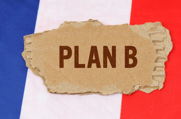 Against the background of the French flag lies cardboard with the inscription - PLAN B