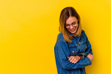 Young caucasian skinny woman isolated on yellow background smiling confident with crossed arms.