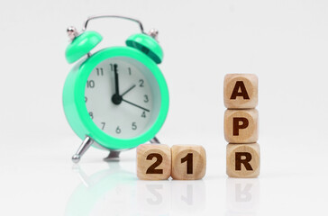 On a white background there is an alarm clock and a calendar with the inscription - April 21