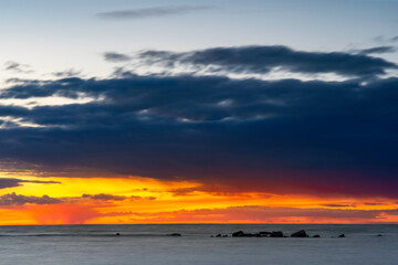 Vibrant summer sunset over calm deep blue ocean, Sweden