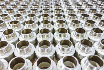 many metal pipe couplings in a pipe factory