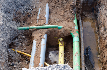 underground services,  including telecom, gas, electricity fibre optic ducts,  exposed for repair during groundworks and new road construction 