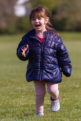 Fototapeta premium Cute Baby Girl Running On A Park