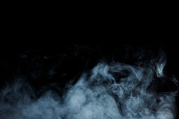 Abstract white smoke moves on black background. Beautiful swirling gray smoke.