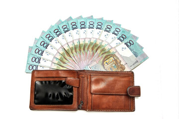 Wallet with paper money in hand isolated on white background. Banknote of one hundred Belarusian rubles. Minimal salary. Living wage budget. Close-up. Offline payments. Cash payment. Financial credit