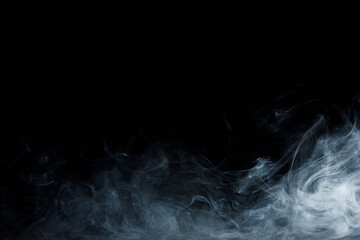 Abstract white smoke moves on black background. Beautiful swirling gray smoke.