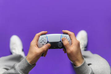 Hand hold new joystick. Gamer play game with gamepad controller. Gaming man holding simulator joypad. Person with keypad joystic in arms. happy to win. Gaming concept. © solidmaks