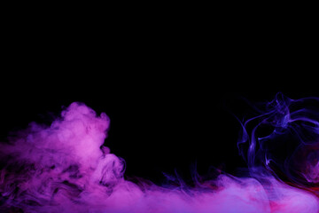 Art photo of purple smoke moves on black background. Beautiful swirling colorful smoke.