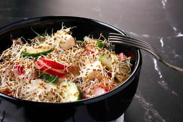 Fresh vegetables salad with feta cheese and lucerne sprouts.