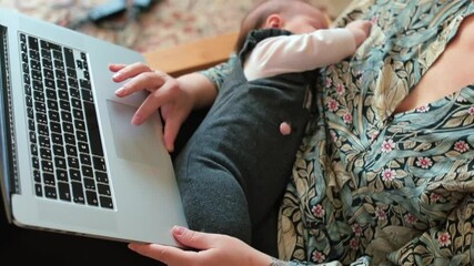 Online courses teach all the basics of newborn and baby care like a sleep schedules and breastfeeding. Parenting classes for moms. Baby with mother during lesson at home. Close up. 