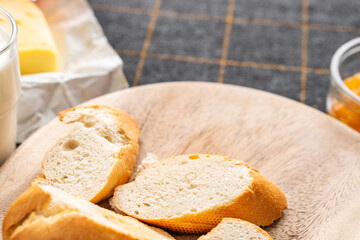 Bread and butter for homemade breakfast with coffee tea milk and organic slide whole wheat rye grain flour brown French  baguette with bio marmalade jam mix with orange passion fruit apricot