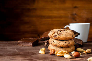 Organic food snack tasty sweet dessert milk dark chocolate chip salt cookie closeup piece fruit orange raspberry hazelnut nuts cinnamon on cocoa cacao powder wooden table for new year Christmas gift