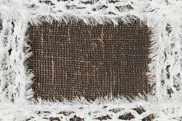 Knitted fabric with fringe on a decorative background