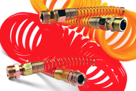 pneumatic hose of a truck for supplying compressed air from a tractor to a trailer, car accessories, car parts, yellow and red,  white background close-up selective focus