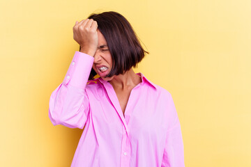 Young mixed race woman isolated on yellow background forgetting something, slapping forehead with...