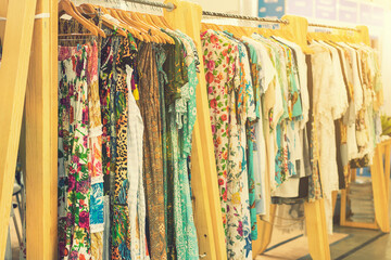 spring and summer women's clothing in the store. bright, modern clothes in a boutique. Women's hip clothing store interior concept. concept of choice of clothing. toned