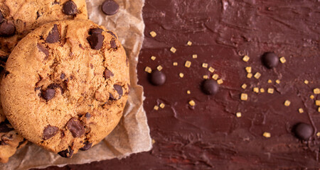 salted cookie round gold concept Organic fresh bake homemade tasty sweet dessert piece of chocolate chip closeup on dark wooden table for holiday new year Christmas gift sugar sparkle