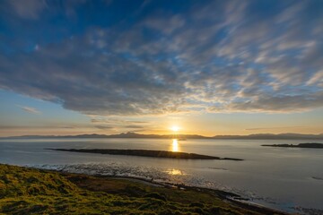 Long exposure photography, mountain landscape, sea bay, small island, the sun is setting