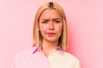 Young caucasian woman face closeup isolated on pink background