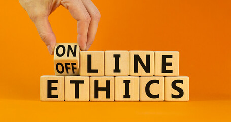 From offline to online ethics. Businessman turns a cube and changes the words 'offline ethics' to...