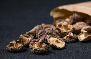 Closeup dried shiitake mushrooms in a brown paper bag