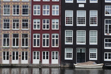 Fototapeta na wymiar Amsterdam Damrak Canal Building Facades Close Up with Boat